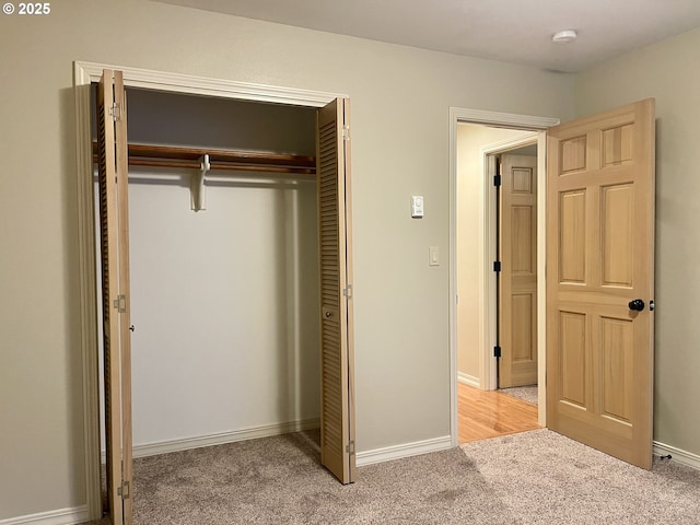 2180 Hayes St, North Bend, OR 97459 - unfurnished bedroom featuring light colored carpet, a closet, and baseboards