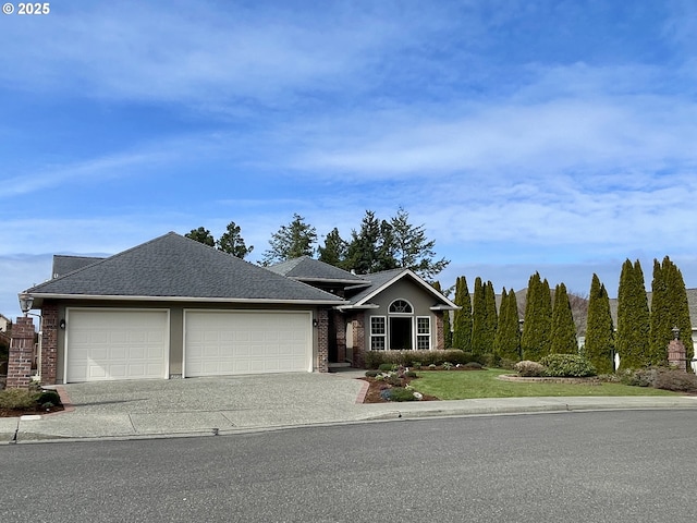 view of front of home featuring driveway, roof with shingles, a front lawn, a garage, and brick siding