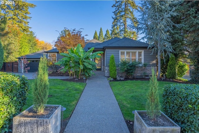 view of front of property with a garage and a front yard