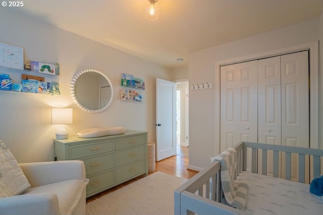 bedroom featuring a closet and light wood-type flooring