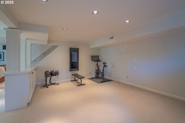 exercise room with light carpet and ornate columns