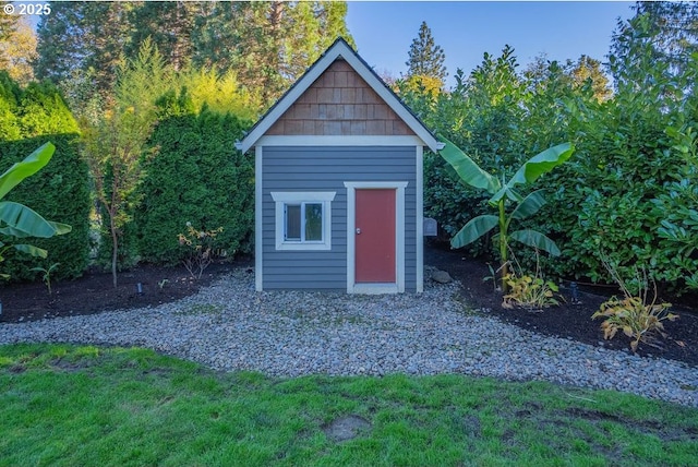 view of outdoor structure featuring a lawn