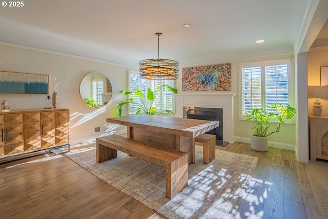 dining space featuring crown molding and light wood-type flooring