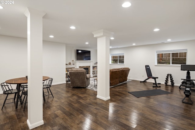 8235 SW 47th Ave, Portland, OR 97219 - exercise room featuring decorative columns, dark wood-style floors, recessed lighting, a fireplace, and baseboards