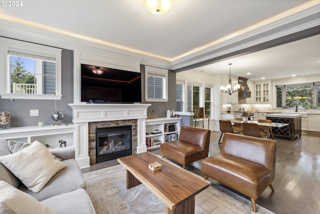 8235 SW 47th Ave, Portland, OR 97219 - living room featuring a chandelier, healthy amount of natural light, a premium fireplace, wood-type flooring, and ornamental molding