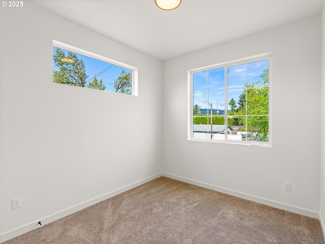7582 N Alma Ave Unit 4, Portland, OR 97203 - carpeted empty room with baseboards