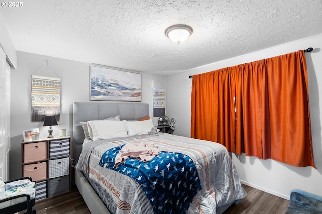 bedroom featuring dark hardwood / wood-style floors and a textured ceiling