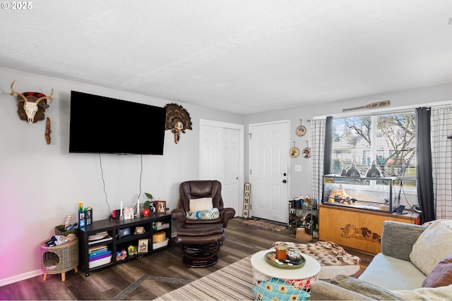 living room featuring dark hardwood / wood-style floors and a textured ceiling