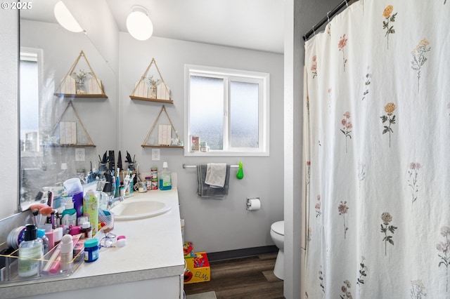 bathroom featuring hardwood / wood-style flooring, vanity, and toilet