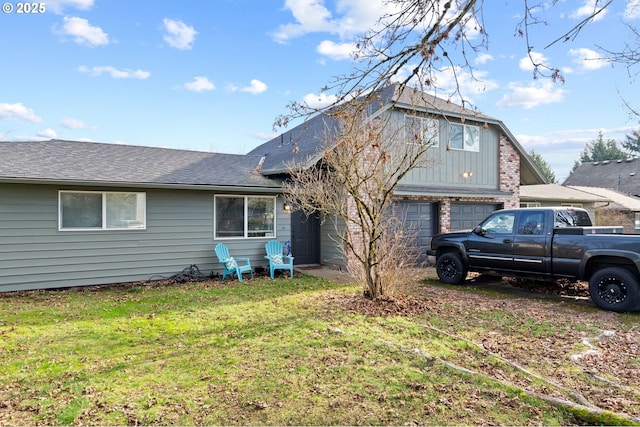 back of house with a garage and a lawn