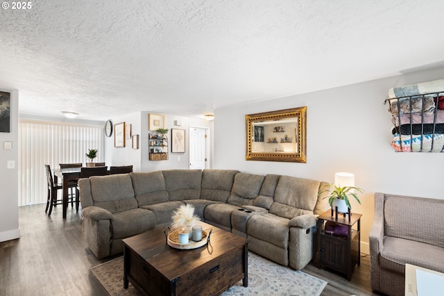 living room featuring wood-type flooring and a textured ceiling