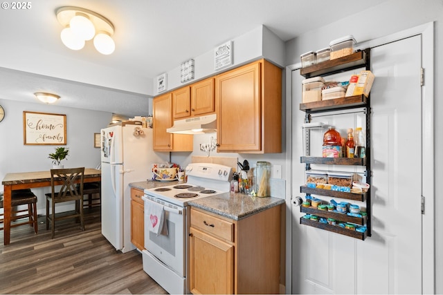 kitchen featuring white appliances, dark hardwood / wood-style flooring, and dark stone countertops