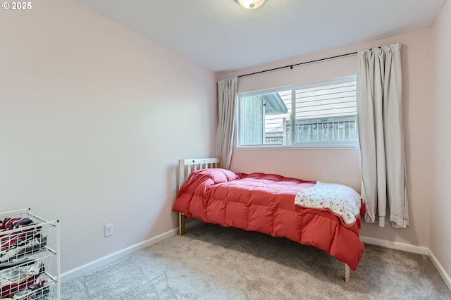 carpeted bedroom featuring baseboards and lofted ceiling