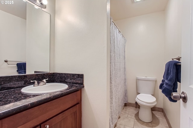 bathroom featuring tile patterned floors, vanity, and toilet