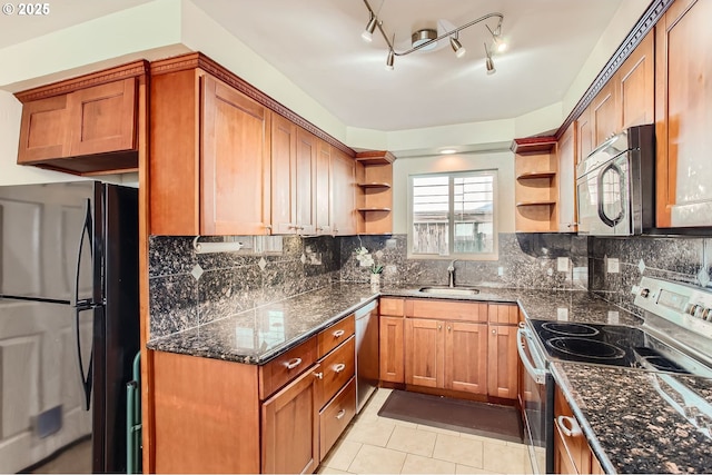 kitchen with appliances with stainless steel finishes, open shelves, light tile patterned floors, and dark stone countertops