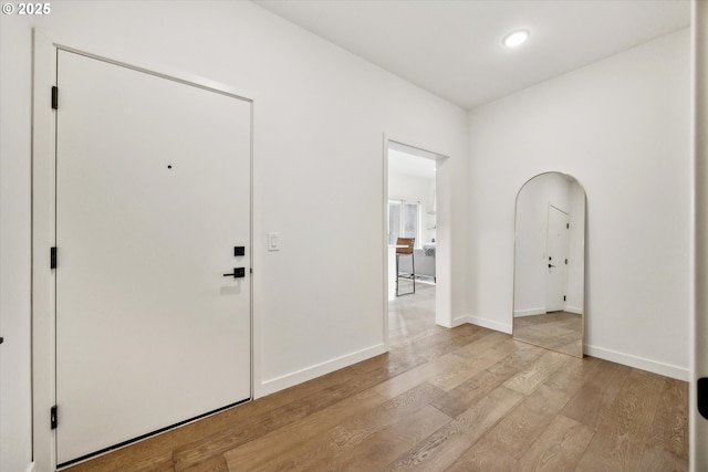 foyer featuring light wood-style floors and baseboards