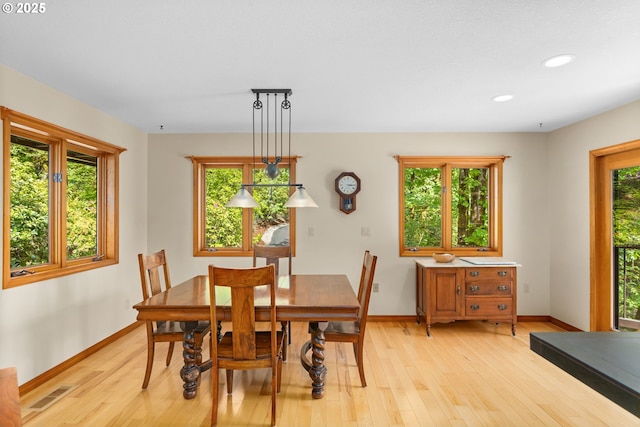 dining room with light wood-style flooring, baseboards, and recessed lighting