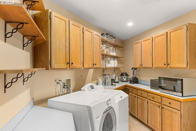 laundry area with washer and dryer, recessed lighting, and cabinet space