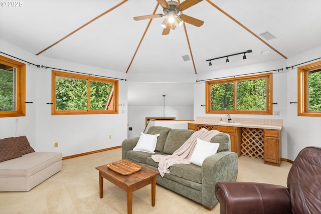living room featuring light carpet, a ceiling fan, and baseboards