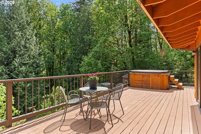 wooden deck with a hot tub