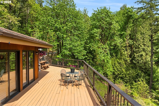 wooden terrace featuring outdoor dining space
