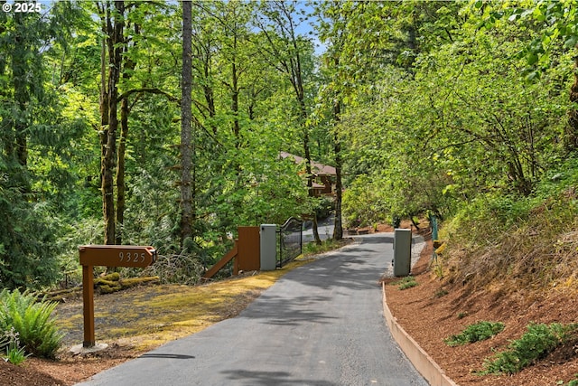 view of home's community featuring a gate and a view of trees