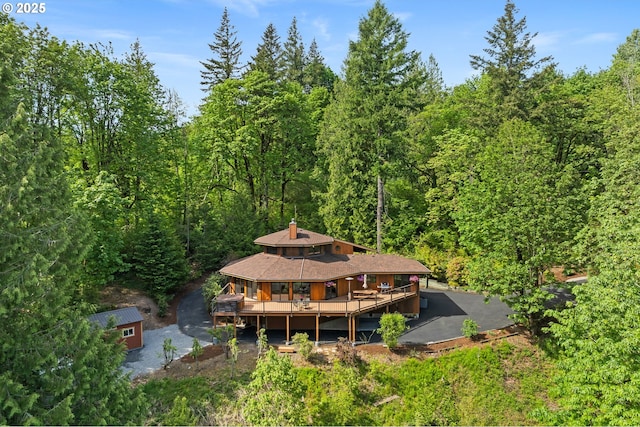 view of subject property featuring a heavily wooded area
