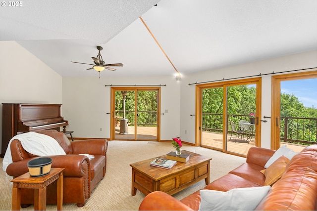 living area featuring lofted ceiling, light carpet, a ceiling fan, baseboards, and healthy amount of natural light