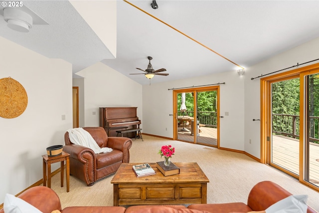 living room with lofted ceiling, baseboards, plenty of natural light, and light colored carpet