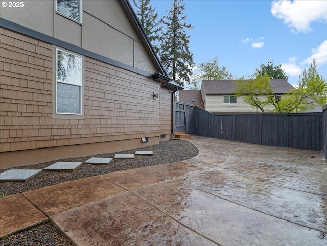 5610 NE Going St, Portland, OR 97218 - view of side of property featuring a patio area, a fenced backyard, and stucco siding