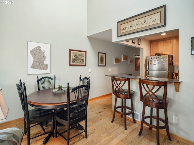 dining space featuring light wood-type flooring