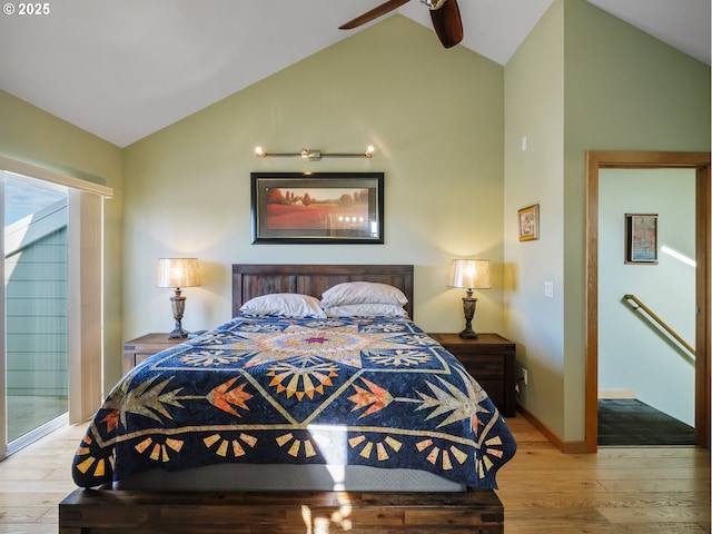 bedroom with ceiling fan, light hardwood / wood-style floors, and vaulted ceiling