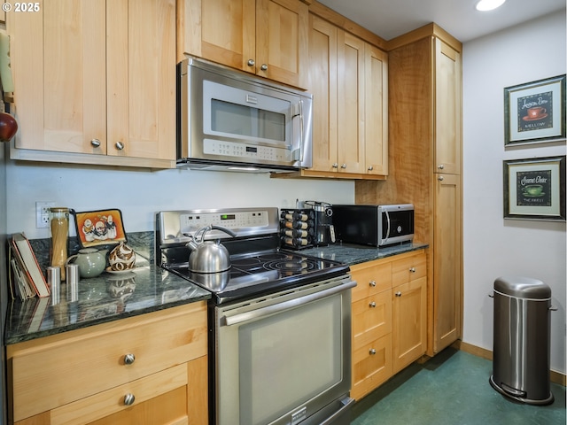 kitchen featuring stainless steel appliances and light brown cabinetry