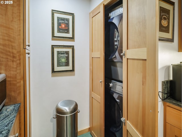 interior space with stacked washer and clothes dryer