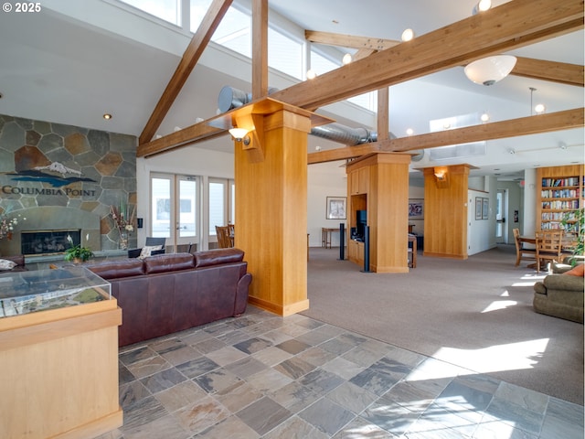 living room featuring french doors, a fireplace, beam ceiling, and dark colored carpet