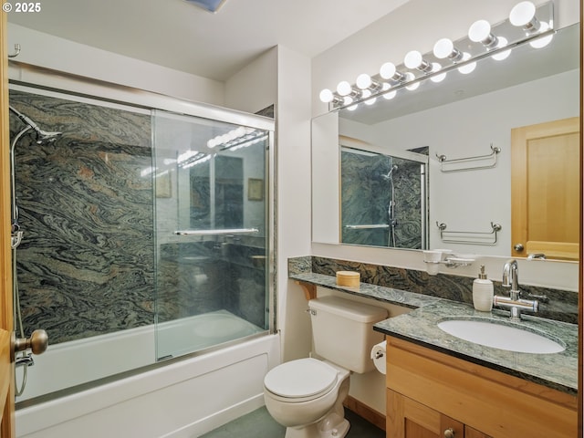 full bathroom with bath / shower combo with glass door, vanity, and toilet