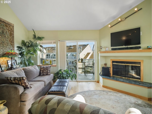 living room with vaulted ceiling and light hardwood / wood-style floors