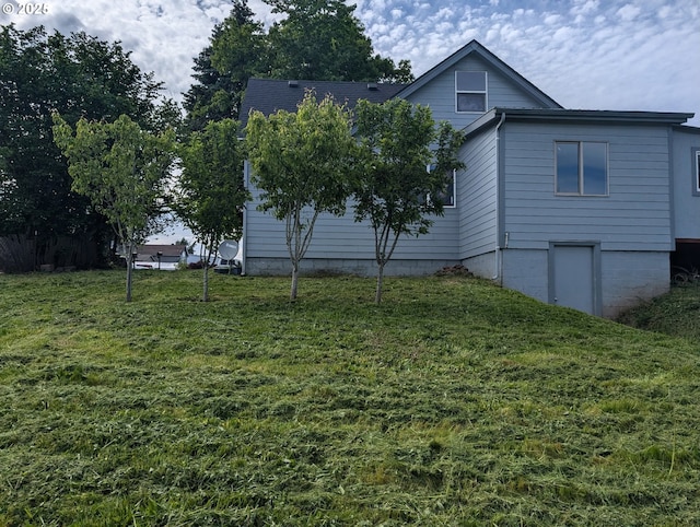 view of side of property with a lawn