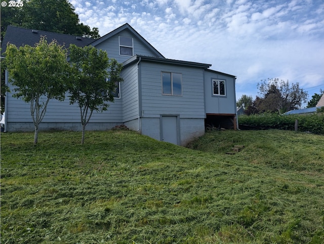 view of side of home featuring a lawn