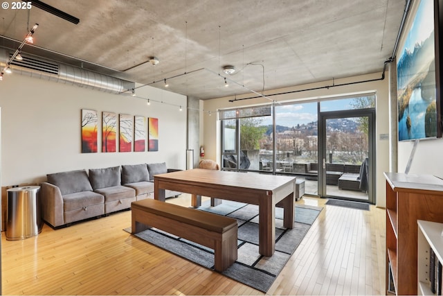 1410 NW Kearney St Unit 717, Portland, OR 97209 - living room featuring light wood finished floors and rail lighting