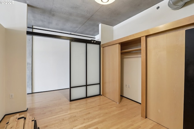 unfurnished bedroom featuring light wood-style flooring