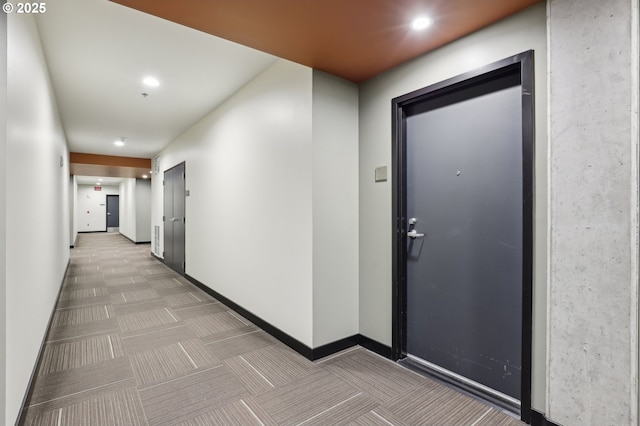 corridor with recessed lighting and baseboards