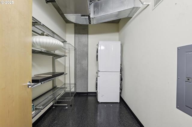 interior space featuring electric panel, visible vents, baseboards, and stacked washer / dryer