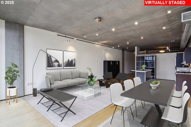 dining room featuring light wood-style floors and visible vents