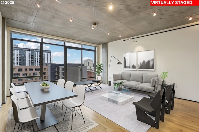 1410 NW Kearney St Unit 717, Portland, OR 97209 - living room featuring wood finished floors, a view of city, and rail lighting