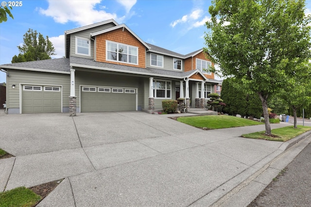 1910 S 15th Cir, Ridgefield, WA 98642 - craftsman-style house featuring concrete driveway, an attached garage, covered porch, and roof with shingles