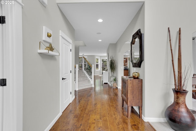 1910 S 15th Cir, Ridgefield, WA 98642 - hall with baseboards, wood-type flooring, recessed lighting, stairs, and arched walkways