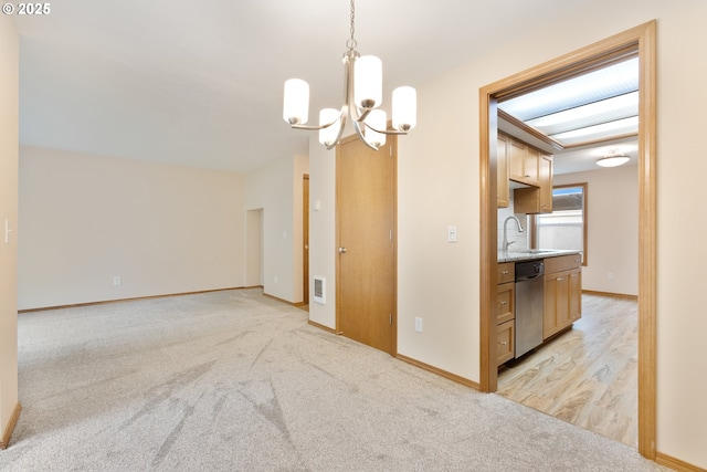 251 NE Village Squire Ave Unit 15, Gresham, OR 97030 - spare room with a sink, a chandelier, light colored carpet, and baseboards