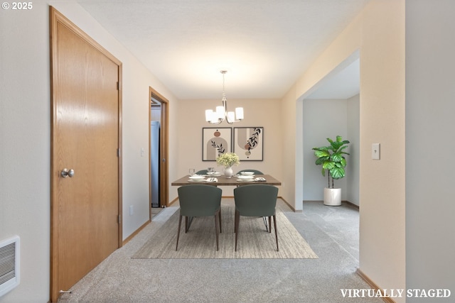 251 NE Village Squire Ave Unit 15, Gresham, OR 97030 - dining space featuring light colored carpet, a chandelier, and baseboards