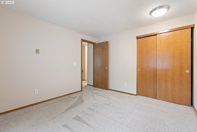 251 NE Village Squire Ave Unit 15, Gresham, OR 97030 - unfurnished bedroom with a closet, carpet, and baseboards
